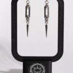 Recta Fang chainmail bar earrings displayed on earring stand by silentchxos