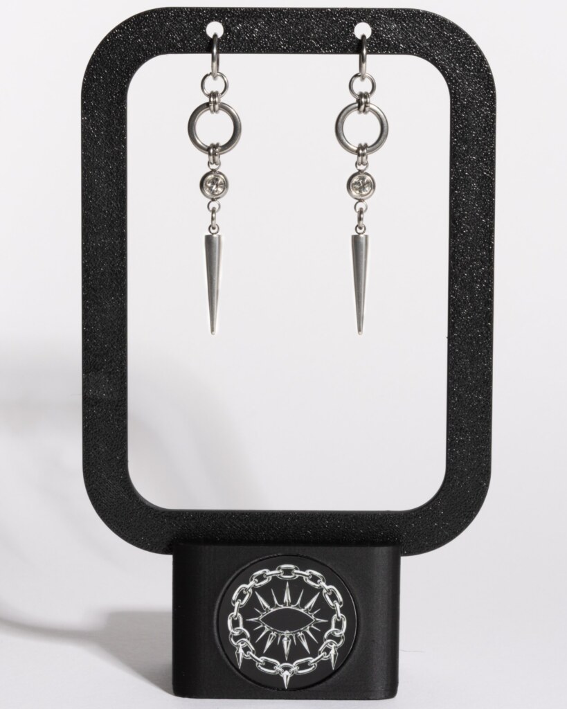 Sparkle Fang chainmail spike earrings displayed on earring stand by silentchxos