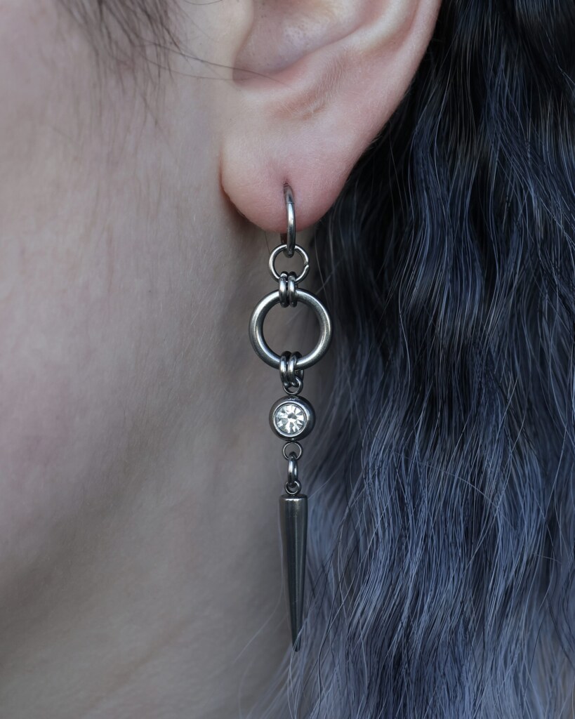 Sparkling Fang, spike chainmail earrings with an rhinestone worn on an ear -close-up by silentchxos