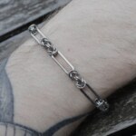 Close up shot of the Bone handmade chainmail bracelet in stainless steel worn on the arm by silentchxos