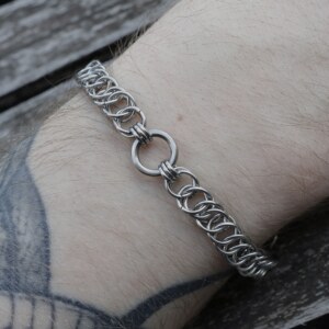 Close up shot of the Fiber handmade chainmail bracelet in stainless steel worn on the arm by silentchxos