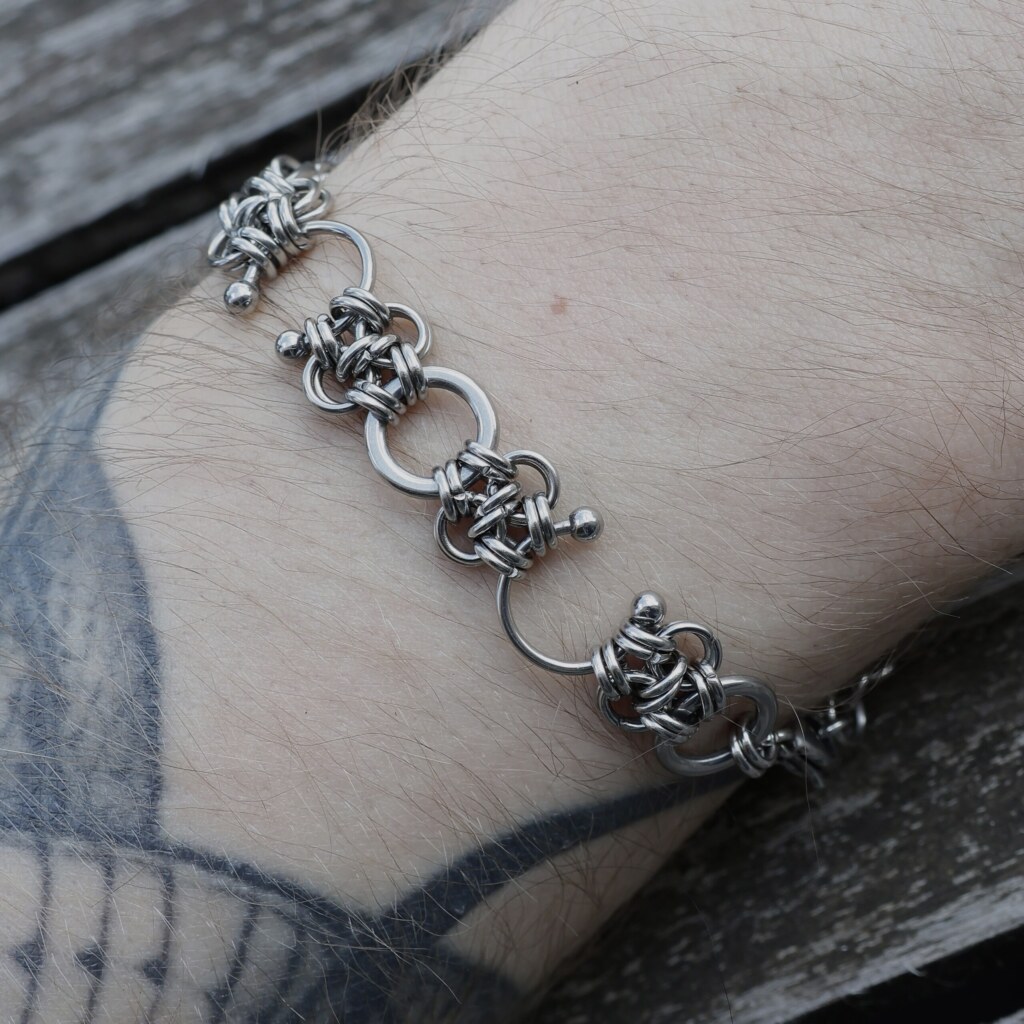 Close up shot of the Piercing handmade chainmail bracelet with Septum Piercings in stainless steel worn on the arm by silentchxos
