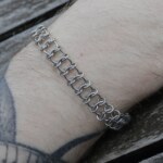 Close up shot of the Spine handmade chainmail bracelet in stainless steel worn on the arm by silentchxos