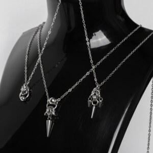 Three handmade stainless steel minimalist necklaces with fine chain and small pendants — triple spike, bead with long spike, and bead with ring — displayed against a white background.